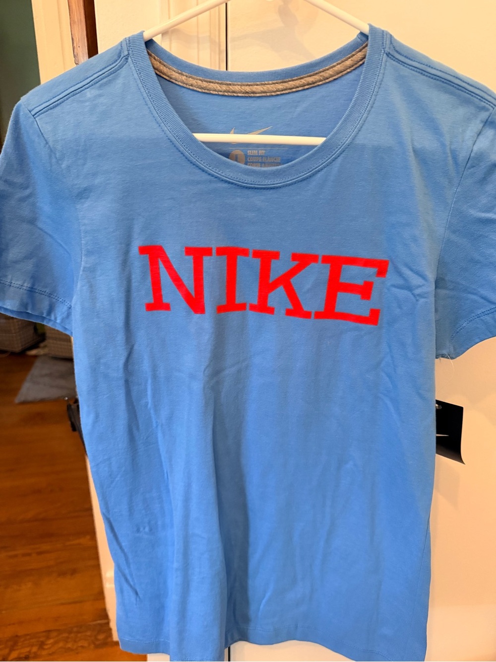 Nike women’s Large Slim Fit Short Sleeve Tee in Sky Blue with Red Logo